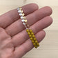 beaded bracelet with yellow glass beads and gold and silver coin chain