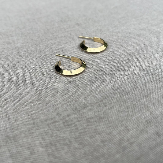 gold hoop earrings on a linen back drop