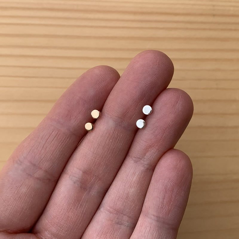 14k gold filled or sterling silver studs in a hand for scale
