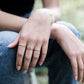 mulitple 14k gold filled stacking rings on a woman's hand