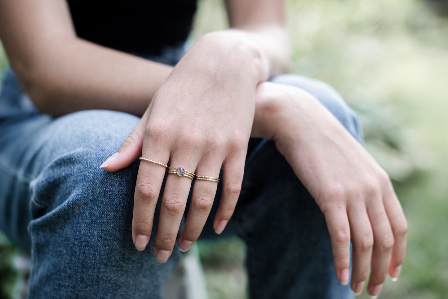 mulitple 14k gold filled stacking rings on a woman's hand