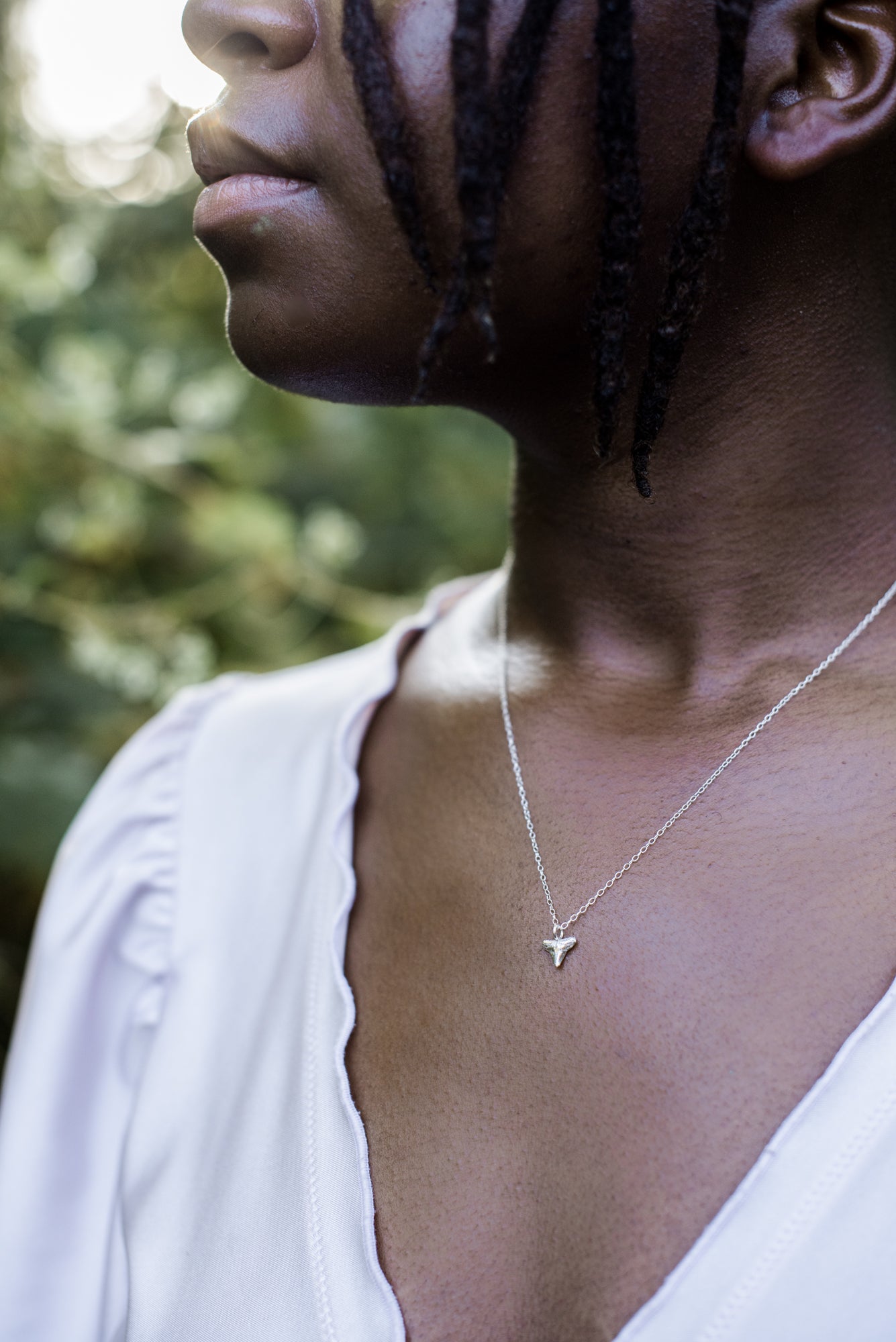 sterling silver shark tooth necklace on a model