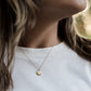 gold vermeil great lakes pendant on a model with brown hair and a white t shirt