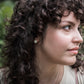 hammered silver earrings on model with curly brown hair