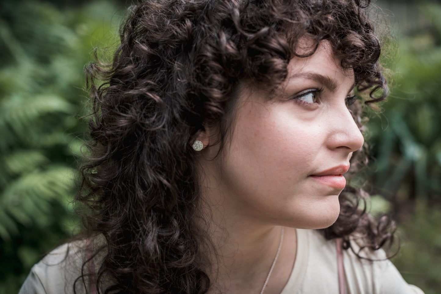 hammered silver earrings on model with curly brown hair