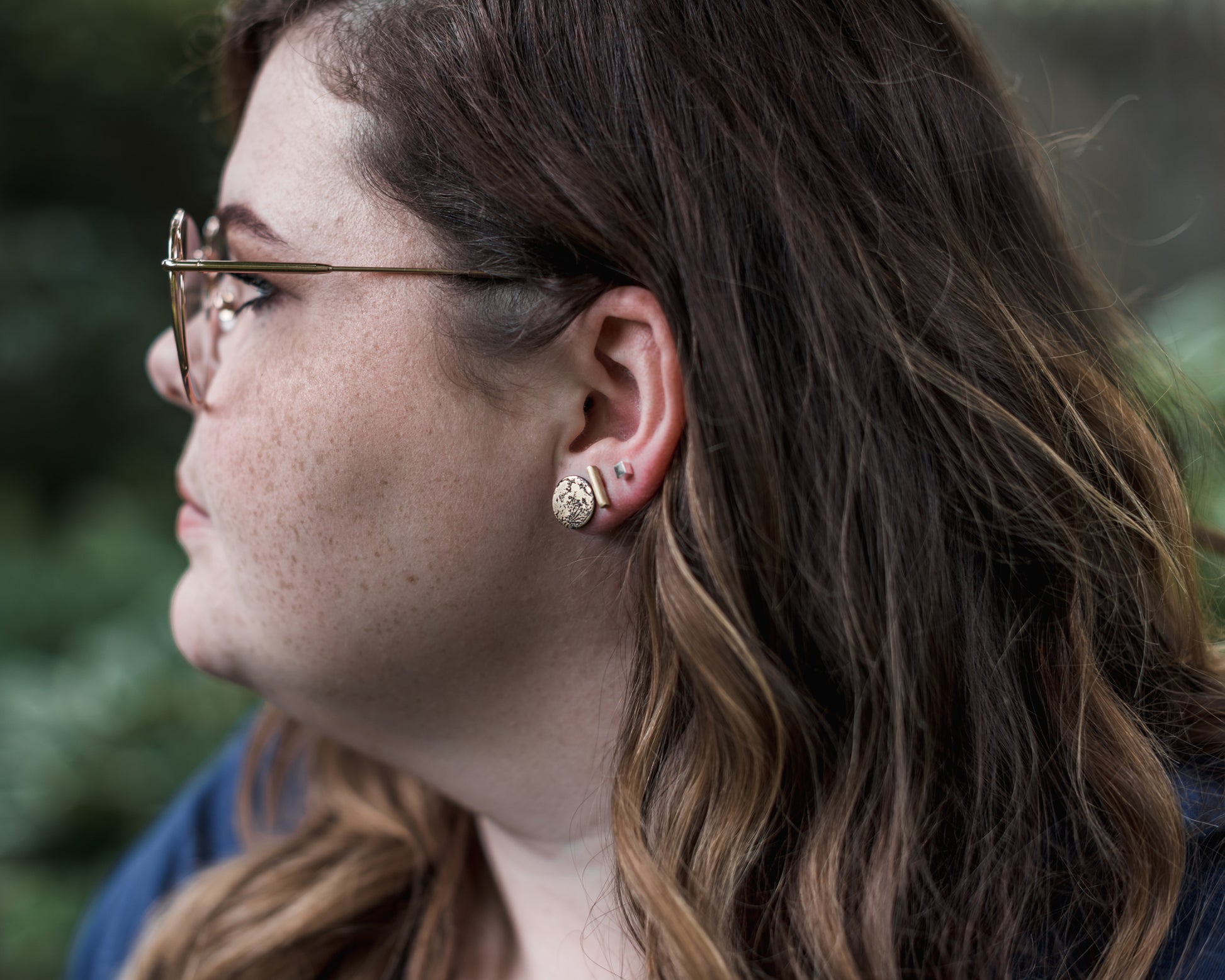 cube studs modeled on a woman
