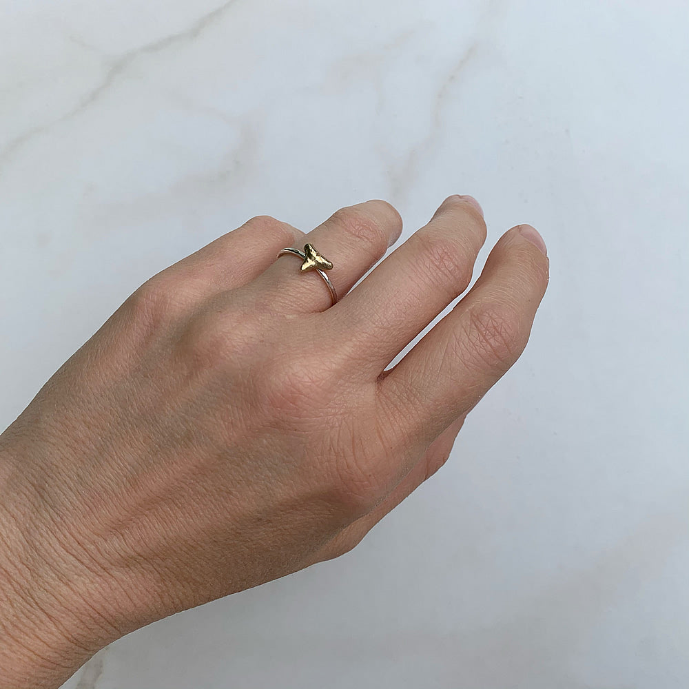 sterling silver and brass shark tooth ring on a hand