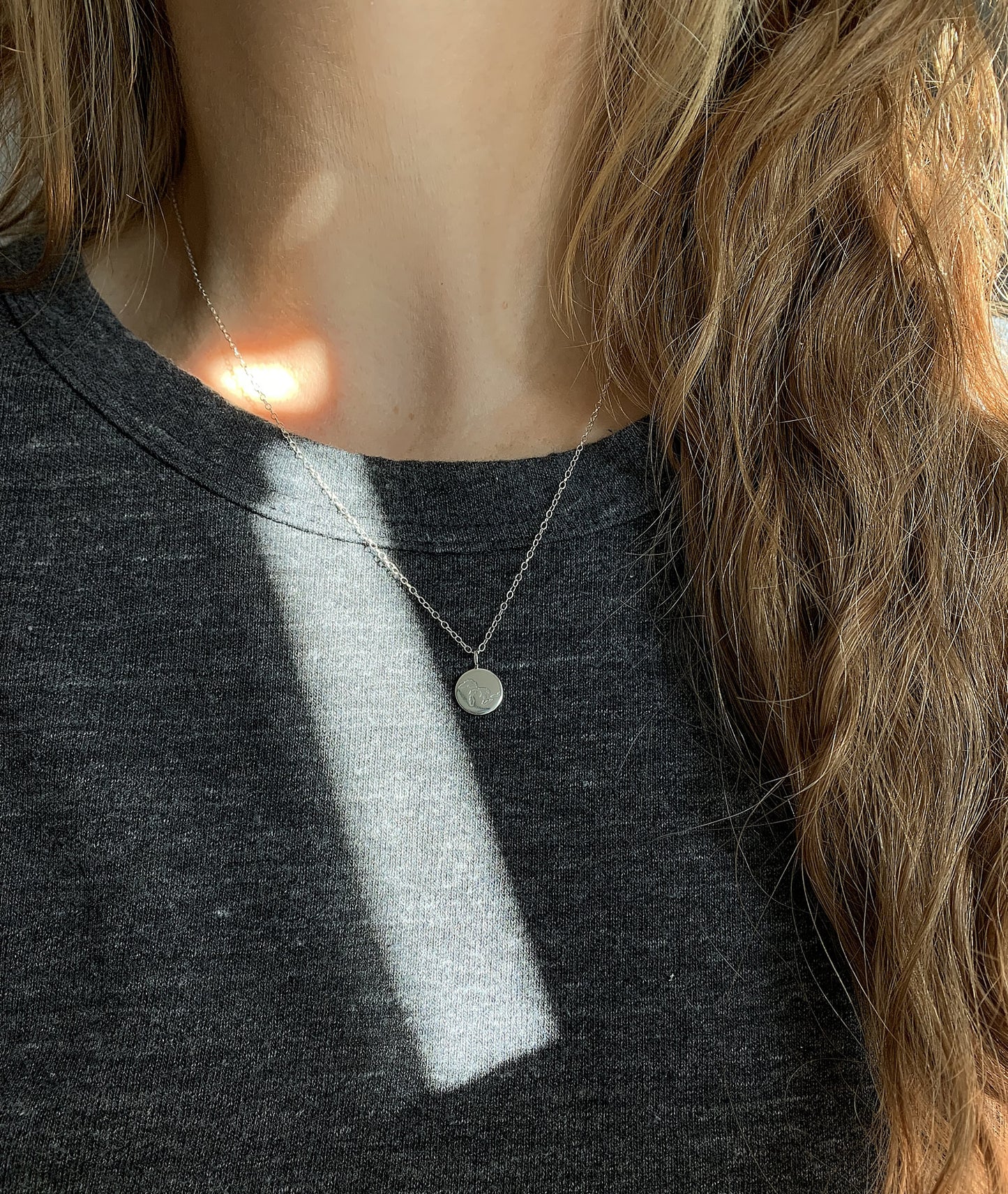 sterling silver michigan necklace modeled on person with grey tshirt