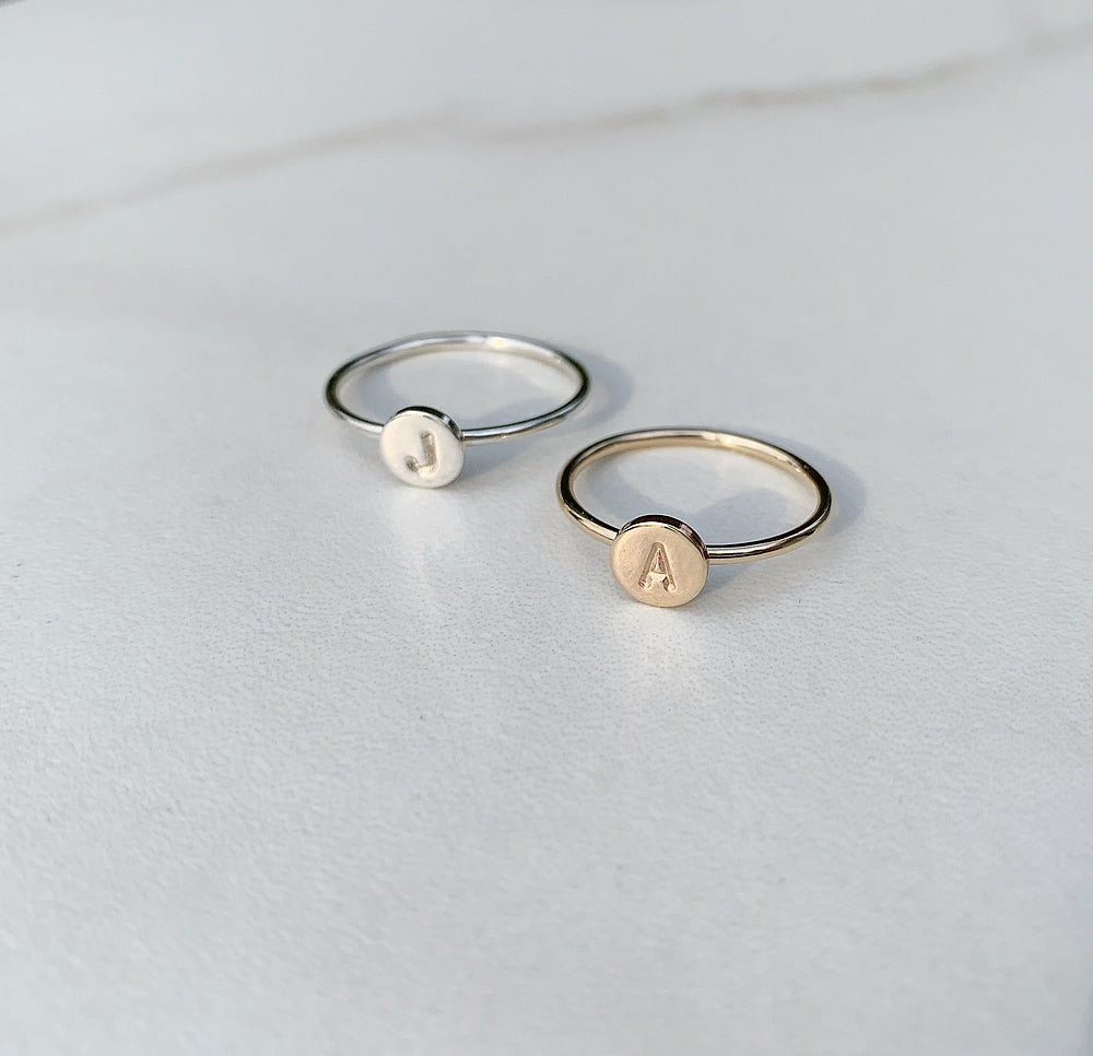 Letter A and letter J stacking rings in gold and silver