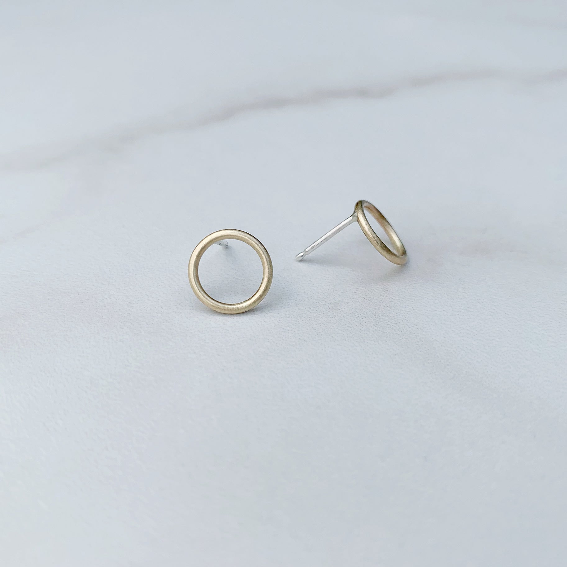 open circle studs in brass, different view