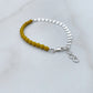 beaded bracelet with yellow glass beads and silver coin chain